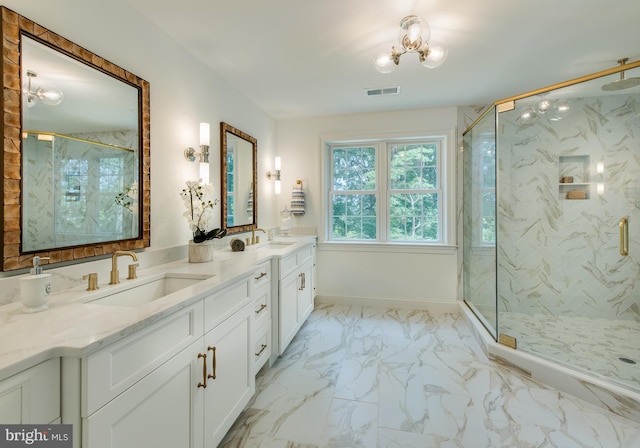 bathroom with an inviting chandelier, vanity, and walk in shower