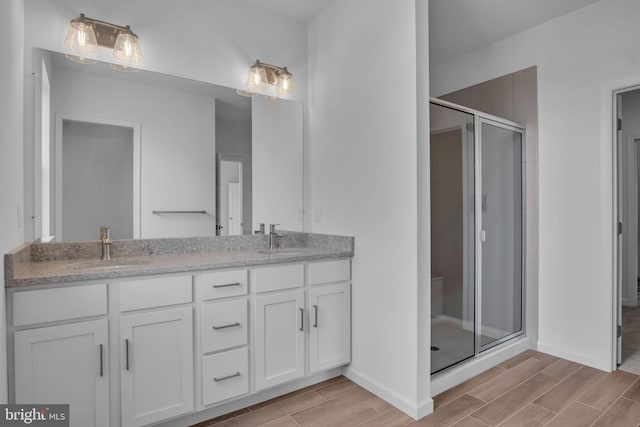 bathroom with vanity and an enclosed shower