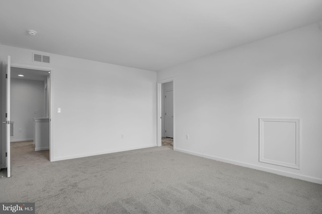 spare room with light carpet