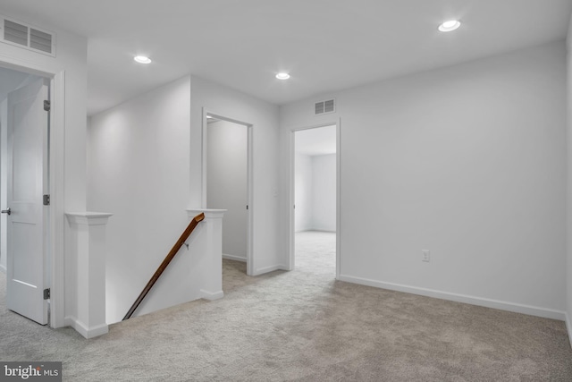 hallway with light colored carpet