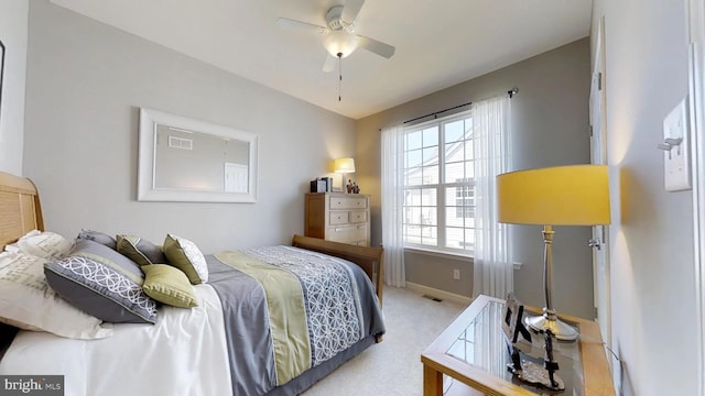 carpeted bedroom with multiple windows and ceiling fan