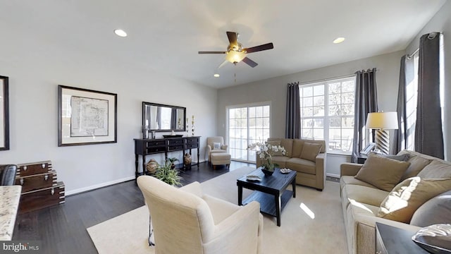 living room with ceiling fan and dark wood-type flooring