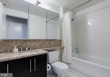 full bathroom with decorative backsplash, vanity, toilet, and shower / bathtub combination with curtain