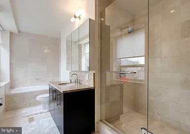 bathroom with vanity and independent shower and bath