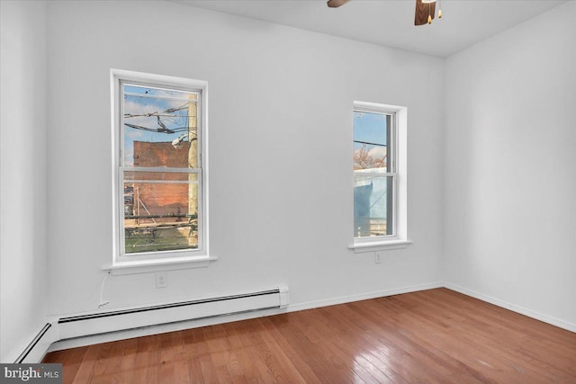 unfurnished room with a healthy amount of sunlight, wood-type flooring, and ceiling fan