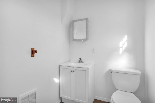 bathroom featuring toilet and vanity