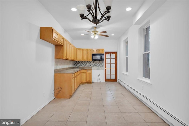 kitchen with tasteful backsplash, ceiling fan with notable chandelier, pendant lighting, a baseboard heating unit, and light tile patterned floors