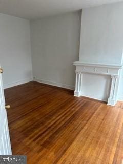 unfurnished living room featuring hardwood / wood-style flooring