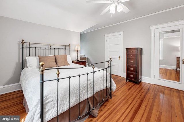 bedroom with baseboards and wood finished floors