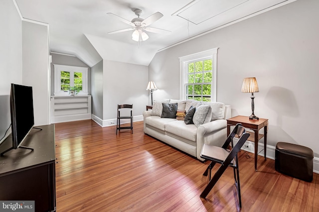 living area featuring a healthy amount of sunlight, attic access, and hardwood / wood-style flooring