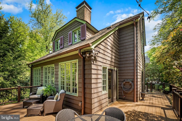 view of property exterior featuring a wooden deck and a chimney