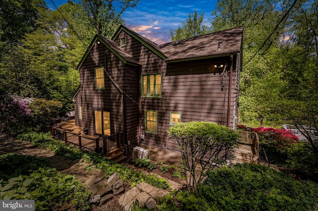 view of home's exterior featuring central AC unit and a wooden deck