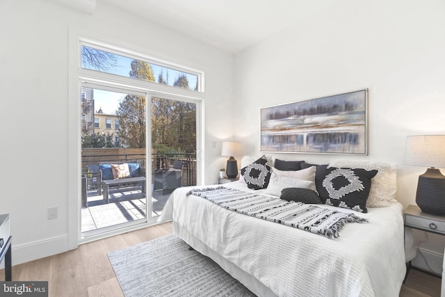 bedroom featuring light hardwood / wood-style flooring and access to outside