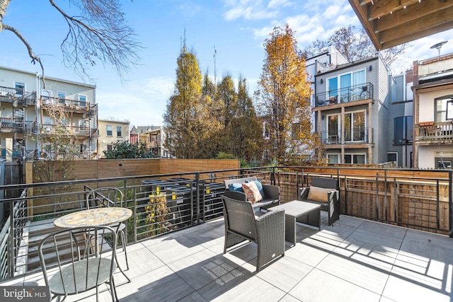 view of patio with a balcony and an outdoor hangout area