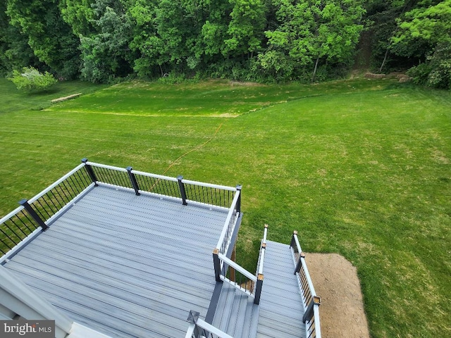 wooden deck with a lawn