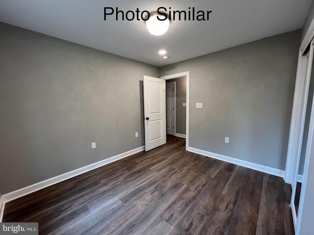 unfurnished bedroom with dark hardwood / wood-style floors