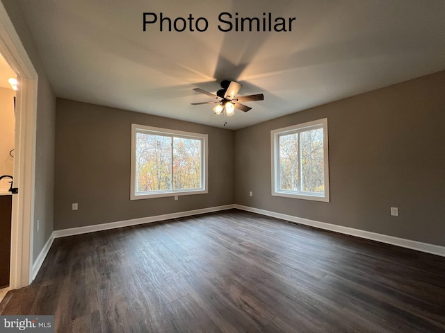 spare room with ceiling fan and dark wood-type flooring