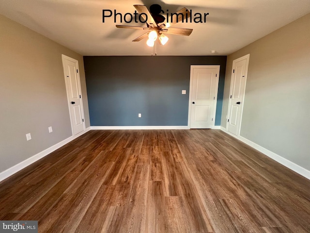 spare room with dark hardwood / wood-style flooring and ceiling fan