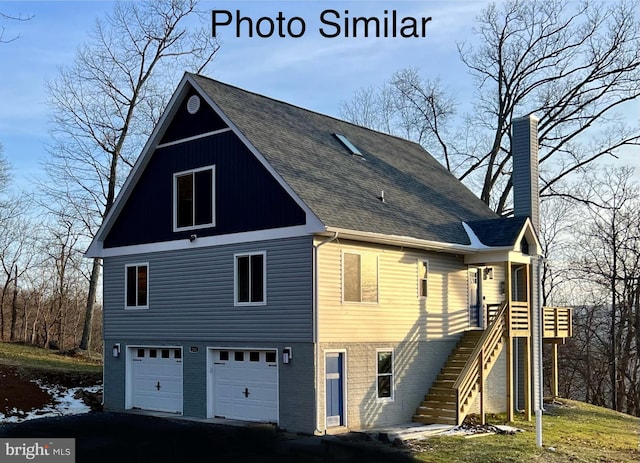 rear view of house with a garage