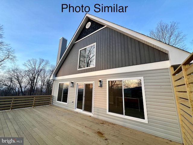 rear view of property with a wooden deck