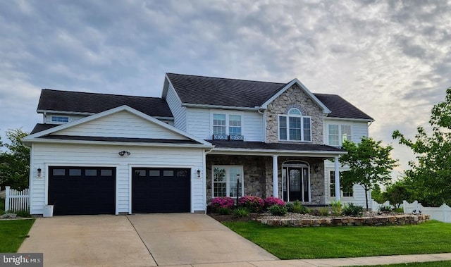 view of front of house with a garage and a front lawn