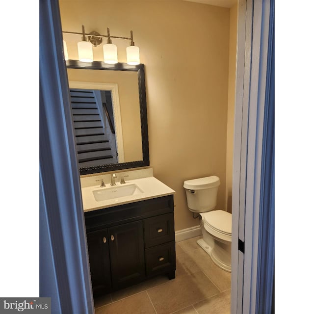 bathroom featuring vanity, toilet, and tile patterned flooring