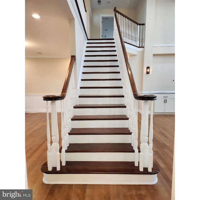 staircase with hardwood / wood-style flooring