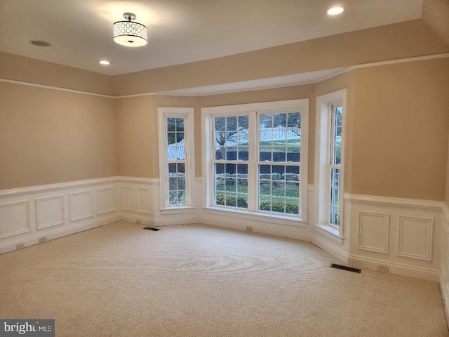 unfurnished room with light carpet