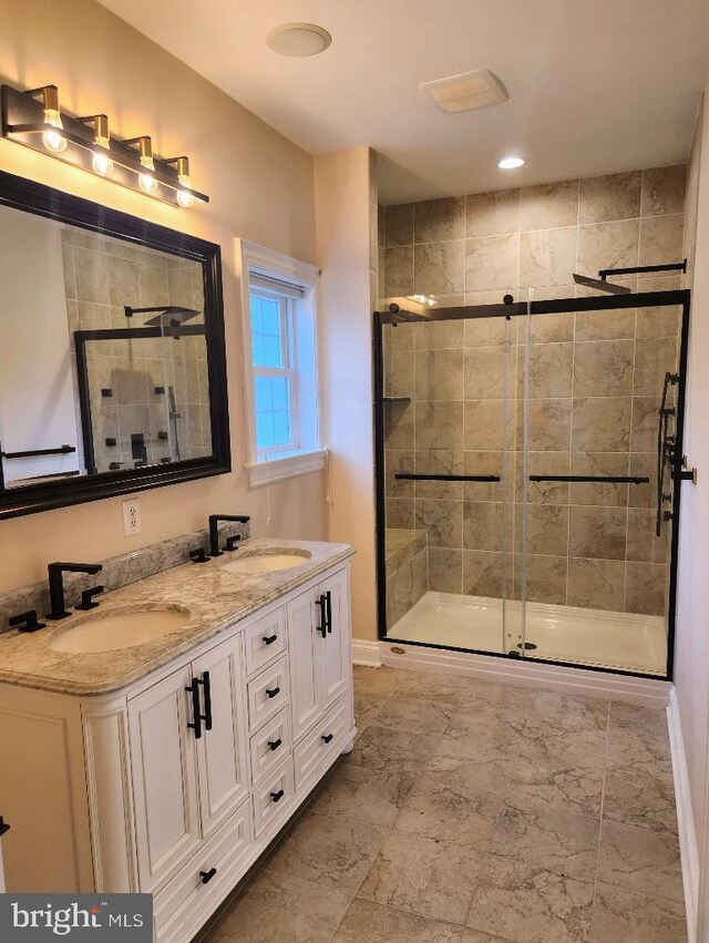 bathroom featuring tile patterned floors, double sink vanity, and an enclosed shower