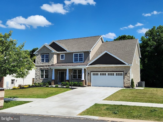 craftsman-style home featuring a porch, central AC unit, a garage, and a front lawn