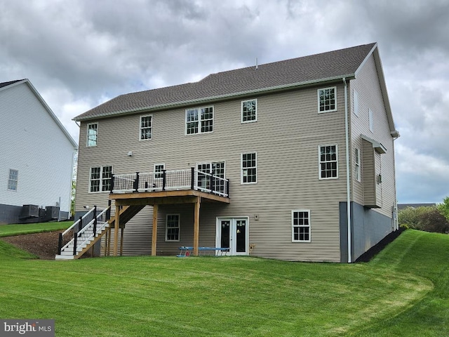 back of house featuring central AC unit, a yard, and a wooden deck