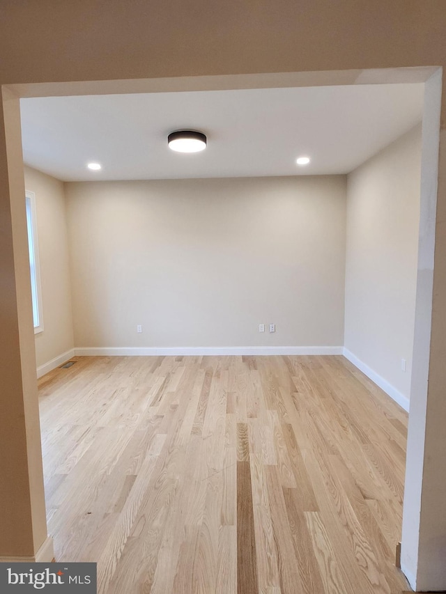 basement with light hardwood / wood-style flooring