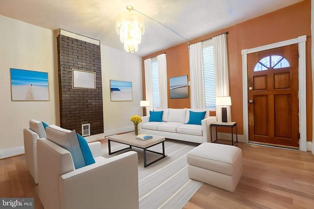 living room featuring light hardwood / wood-style floors and an inviting chandelier