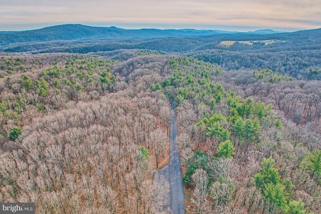 aerial view at dusk featuring a mountain view