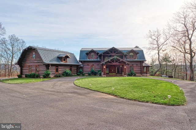 log cabin with a front lawn