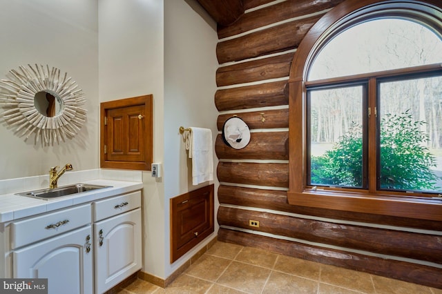 bathroom featuring vanity and rustic walls