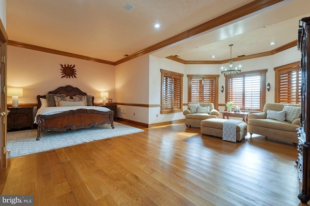 bedroom with a chandelier, crown molding, and light hardwood / wood-style flooring