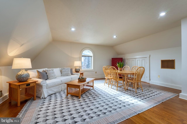 living room with hardwood / wood-style flooring and vaulted ceiling