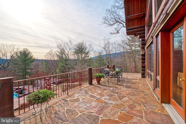 patio terrace at dusk featuring a mountain view