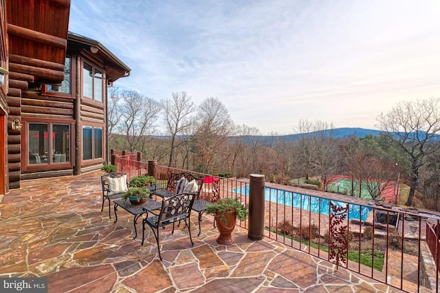 view of patio featuring a fenced in pool and a mountain view