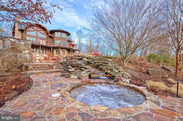 view of patio with a jacuzzi