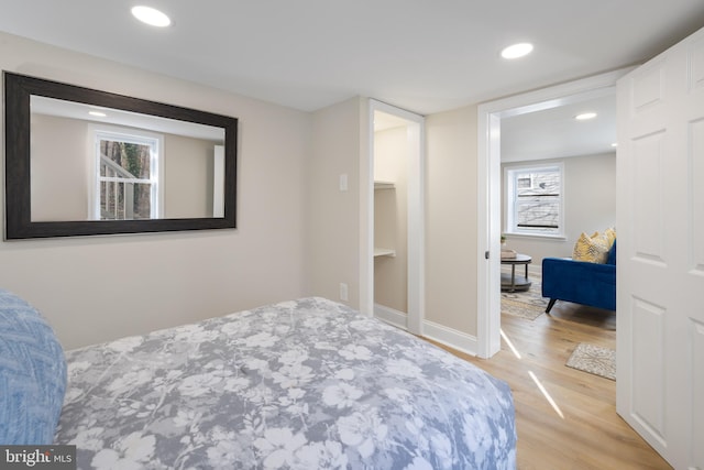 bedroom featuring multiple windows and light hardwood / wood-style floors