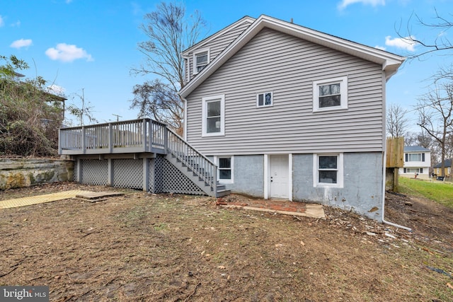 rear view of house with a wooden deck