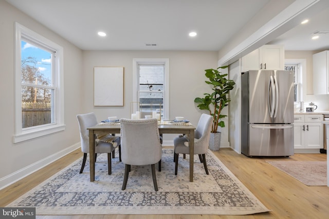 dining area with light hardwood / wood-style floors