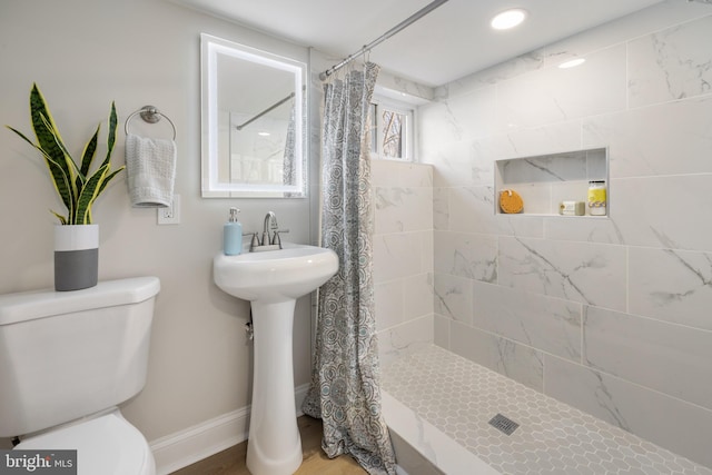 bathroom with toilet and walk in shower