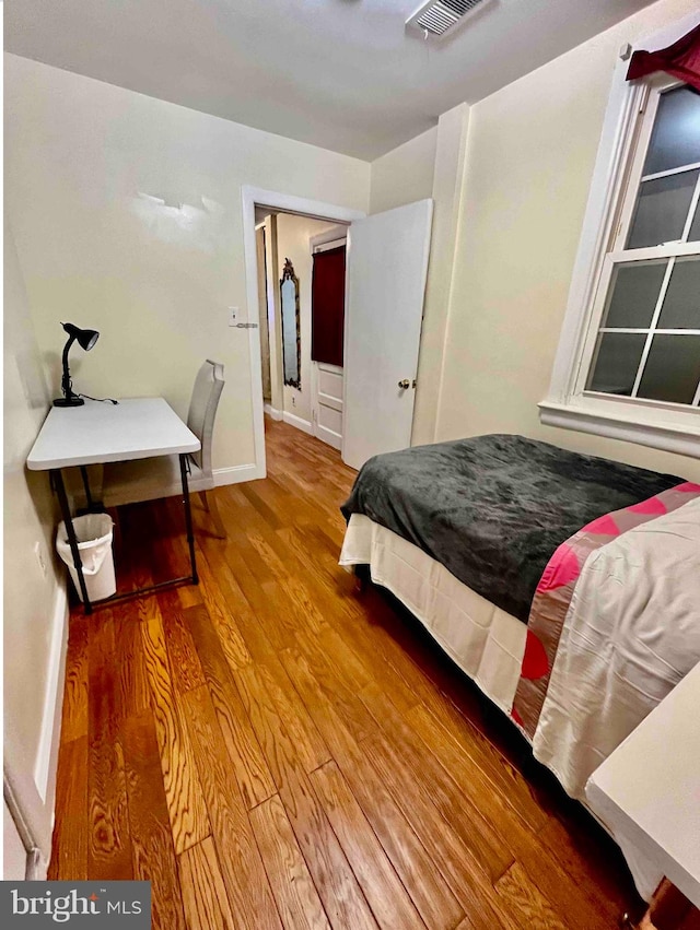 bedroom with hardwood / wood-style floors