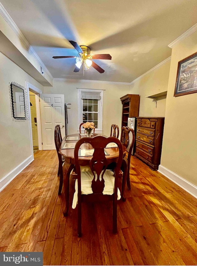 dining space featuring ceiling fan, crown molding, and hardwood / wood-style floors