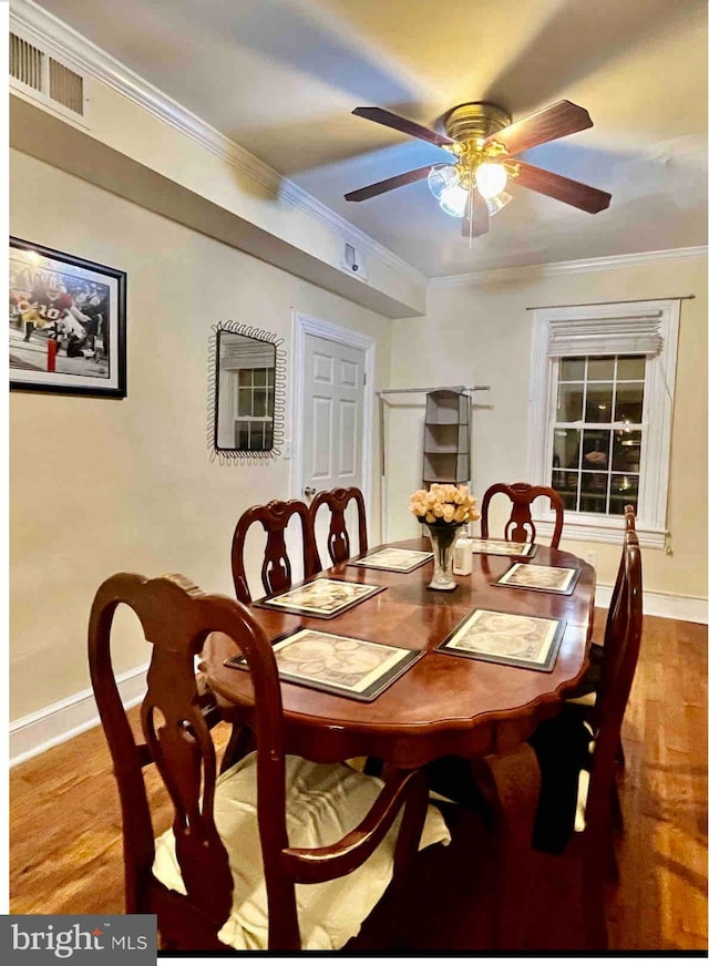 dining space with ornamental molding, ceiling fan, and light wood-type flooring