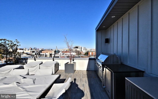 wooden terrace with a grill and exterior kitchen