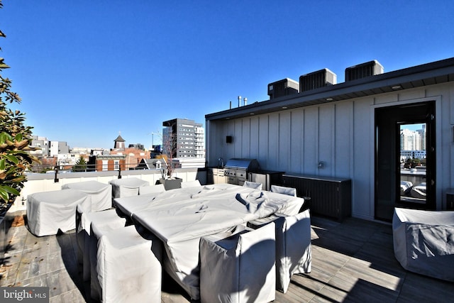 wooden terrace with a grill and central air condition unit